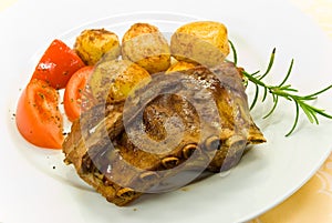 A roasted suckling pig with potatoes and salad