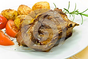 A roasted suckling pig with potatoes and salad