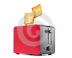 Roasted toast bread popping up of red toaster, isolated on white background. File contains a path to isolation.