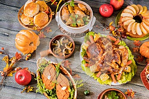 Roasted turkey garnished with many dishes on the table. Thanksgiving Day