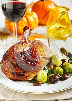 Roasted turkey leg garnished with mash potato, chestnuts and brussels sprouts