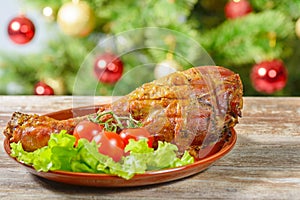 Roasted turkey leg over christmas tree background
