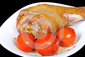 Roasted turkey leg with tomatoes