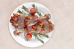 Roasted turkey legs on white plate