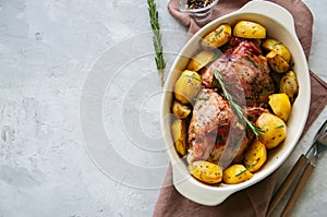 Roasted turkey with rozemary and potatoes in a dish on a white s photo
