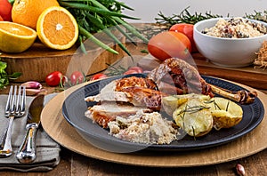 Roasted turkey served on a plate with farofa, crumbs and boiled potatoes. Thanksgiving Day and Christmas dinner