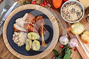 Roasted turkey served on a plate with farofa, crumbs and boiled potatoes. Thanksgiving Day and Christmas dinner