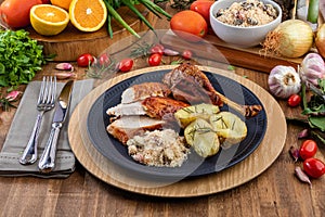 Roasted turkey served on a plate with farofa, crumbs and boiled potatoes. Thanksgiving Day and Christmas dinner