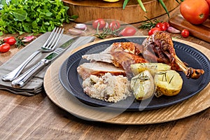 Roasted turkey served on a plate with farofa, crumbs and boiled potatoes. Thanksgiving Day and Christmas dinner