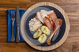 Roasted turkey served on a plate with farofa, crumbs and boiled potatoes. Thanksgiving Day and Christmas dinner. Top view