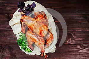 Roasted Turkey. Thanksgiving table served with turkey, decorated with greens and basil on dark wooden background. Homemade roasted