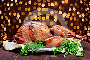 Roasted Turkey. Thanksgiving table served with turkey, decorated with greens and basil on dark wooden background. Homemade roasted