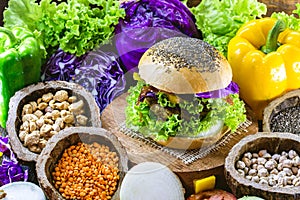 Roasted vegan hamburger, made of vegetables and proteins. Healthy and vegetarian life concept. Colorful food, peppers, red cabbage