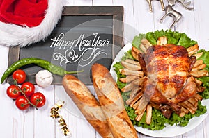 Roasted whole chicken and apple pie with Christmas decoration. Christmas dinner. Thanksgiving table served with turkey