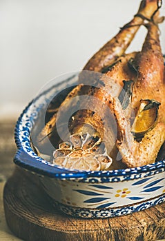 Roasted whole chicken with garlic for Christmas eve celebration table