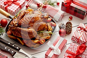 Roasted whole chicken or turkey served in iron pan with Christmas decoration