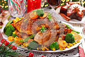 Roasted whole chicken with vegetables on christmas table