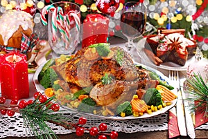 Roasted whole chicken with vegetables on christmas table