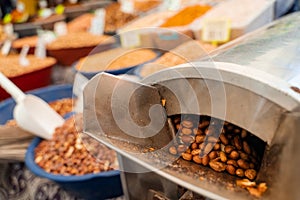 Roasting and blanching peanuts. Process of peeling peanuts in machine.