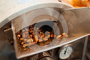 Roasting and blanching peanuts. Process of peeling peanuts in machine.