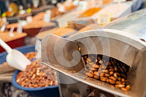 Roasting and blanching peanuts. Process of peeling peanuts in machine.