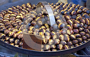 Roasting chestnuts on the grill by a street vendor in Rome