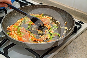 Roasting chopped vegetables on frying pan