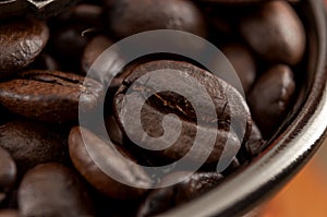 Roasting classic java and rich taste concept macro close up on coffee beans in vintage grinder