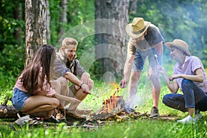 Roasting marshmallows popular group activity around bonfire. Company friends prepare roasted marshmallows snack nature