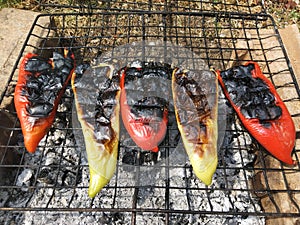 Roasting peppers on barbeque fire