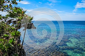 Roatan island Honduras. Landscape, seascape of a tropical blue turquoise clear ocean water, reef. Blue sky in the background. Gree