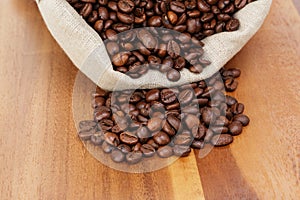 Roated coffee beans spill out of the bag