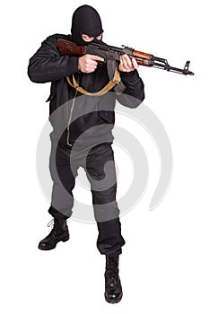 Robber in black uniform and mask with kalashnikov