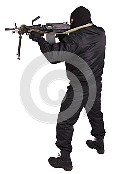 Robber in black uniform and mask with machine gun