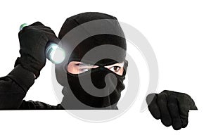 Robber hiding under a white wall