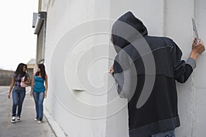 Robber With Knife Hiding Behind Corner And Waiting For Two Girls