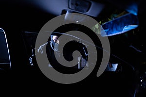 Robber looking thru car window. Car robbery concept