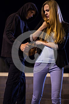 Robber stealing bag from woman