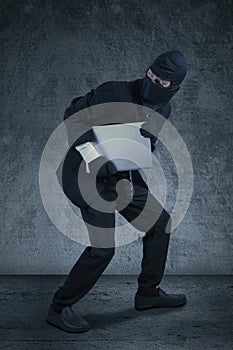 Robber stealing notebook computer