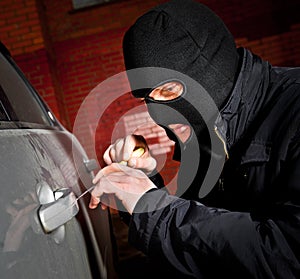 Robber and the thief in a mask hijacks the car