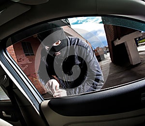 Robber and the thief in a mask hijacks the car