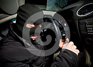 Robber and the thief in a mask hijacks the car