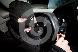 Robber and the thief in a mask hijacks the car