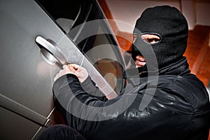 Robber and the thief in a mask hijacks the car