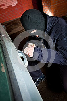 Robber and the thief in a mask hijacks the car