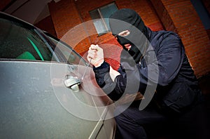 Robber and the thief in a mask hijacks the car