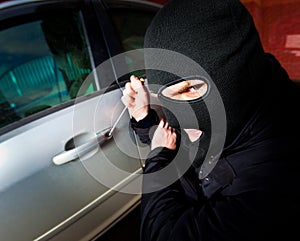 Robber and the thief in a mask hijacks the car