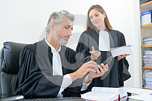 Robed legal workers in discussion photo