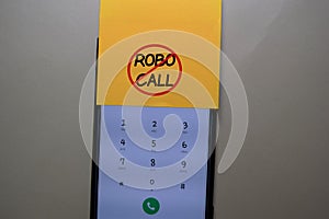 Robocall write on a sticky note isolated on office desk