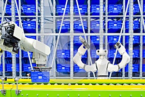 Robot and AI robotic to transport blue plastic crates via conveyor on factory warehouse